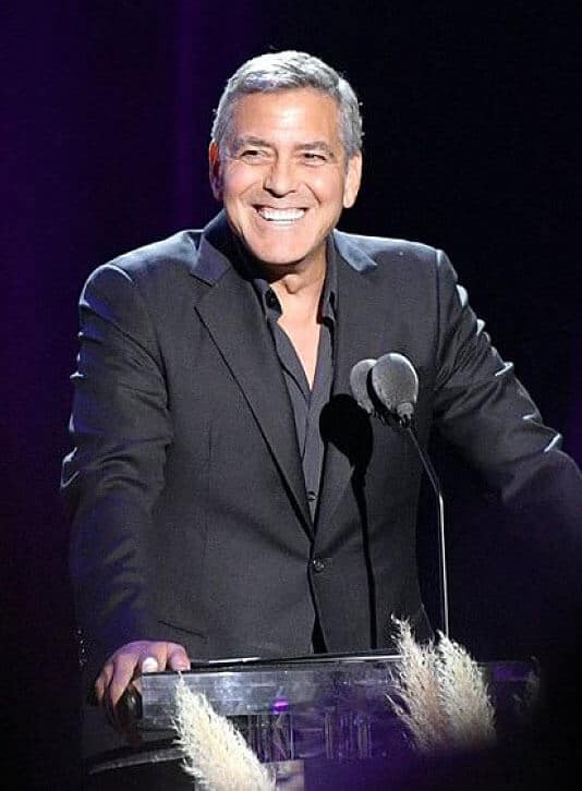 George Clooney speaks from a podium.