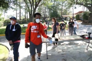 A group of people wearing face masks in a park.