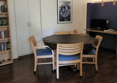 Table and chairs next to a bookshelf