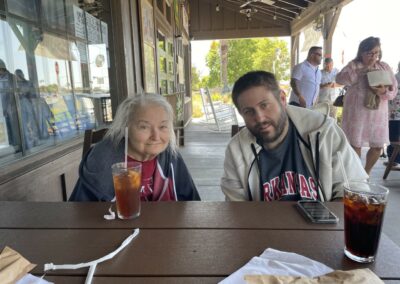 A man and woman sitting at a table with drinks.