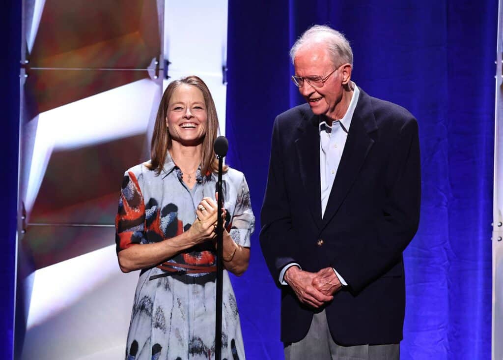 A man and woman standing next to each other on stage.