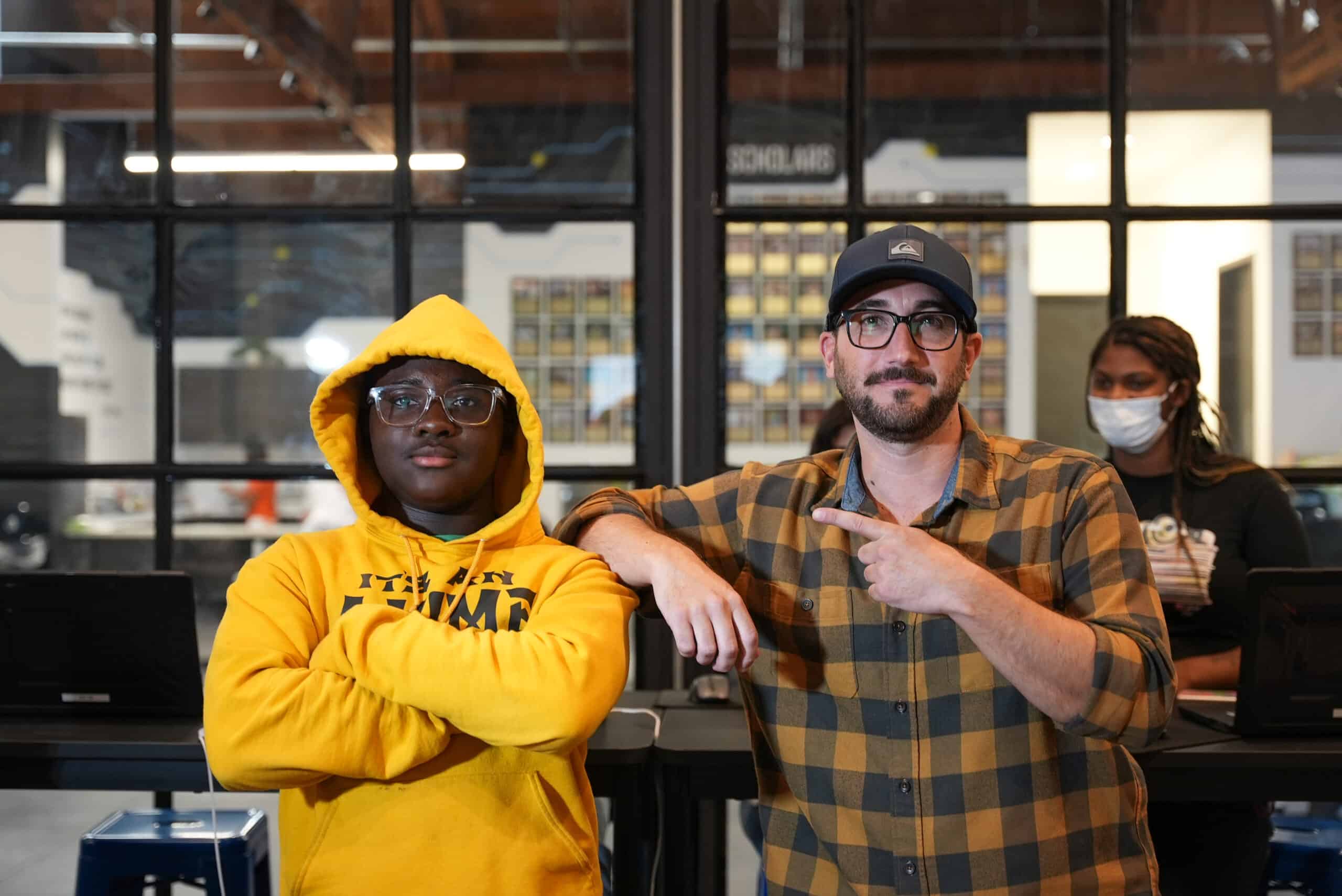 Two men standing next to each other in an office.