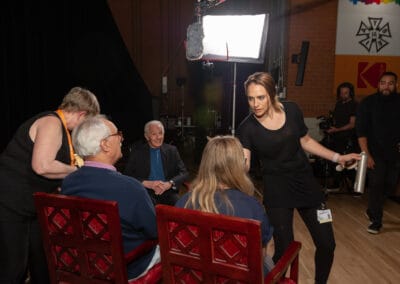 A group of people sitting around a table in front of a camera.