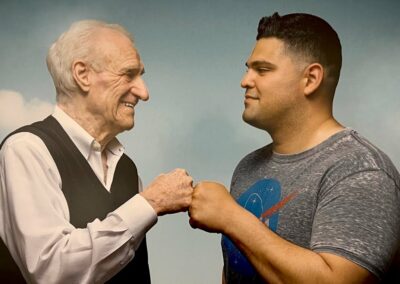 An older man and a younger man are standing next to each other.