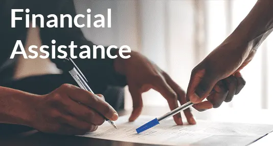 Two people signing a document with the words financial assistance.